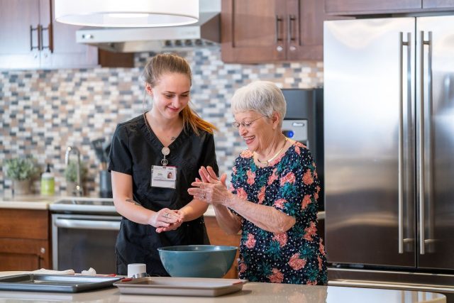 A med tech works at Bridgewater Retirement Community with a Memory Support resident