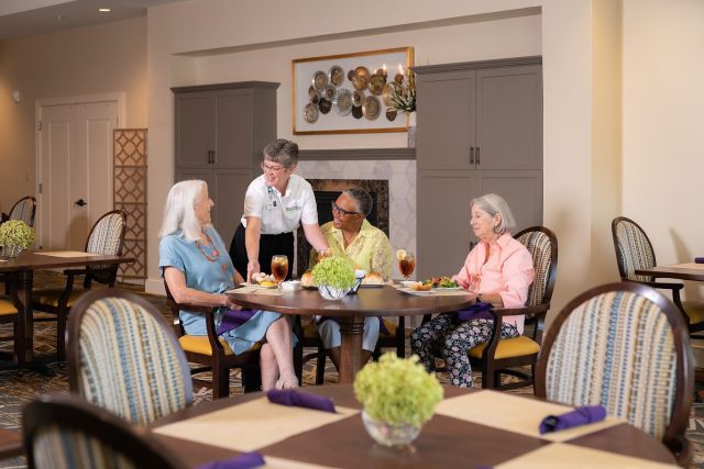 A server works at Bridgewater Retirement Community in the Custer Dining Room