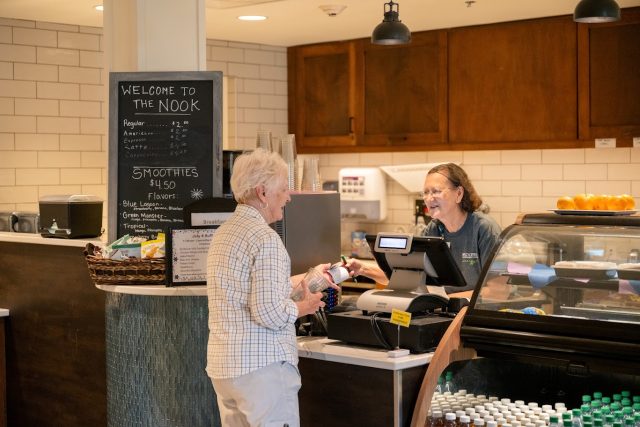 A cashier works at the Junction in Independent Living at Bridgewater Retirement Community